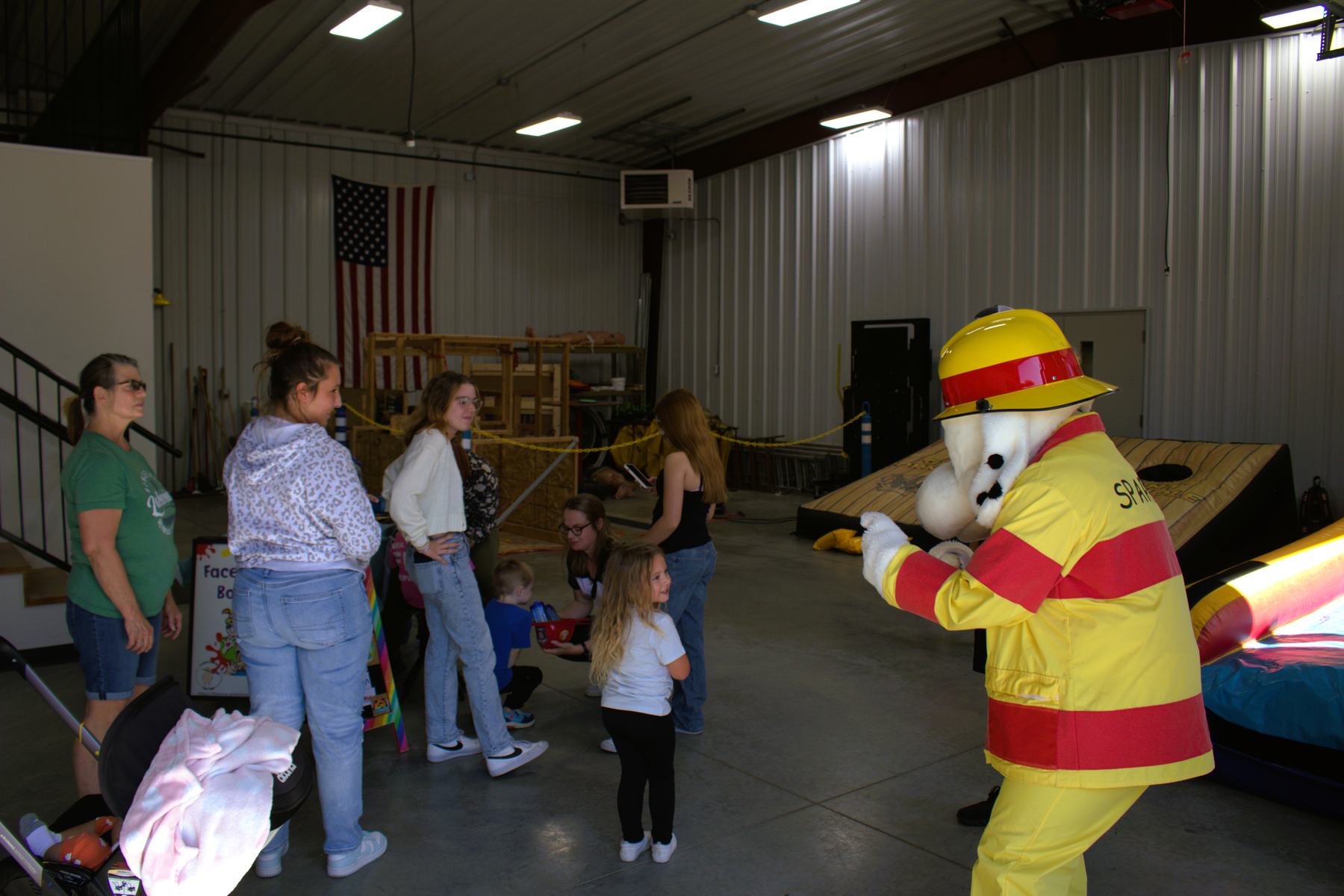 Sparky the Fire Dog greeting families inside the station