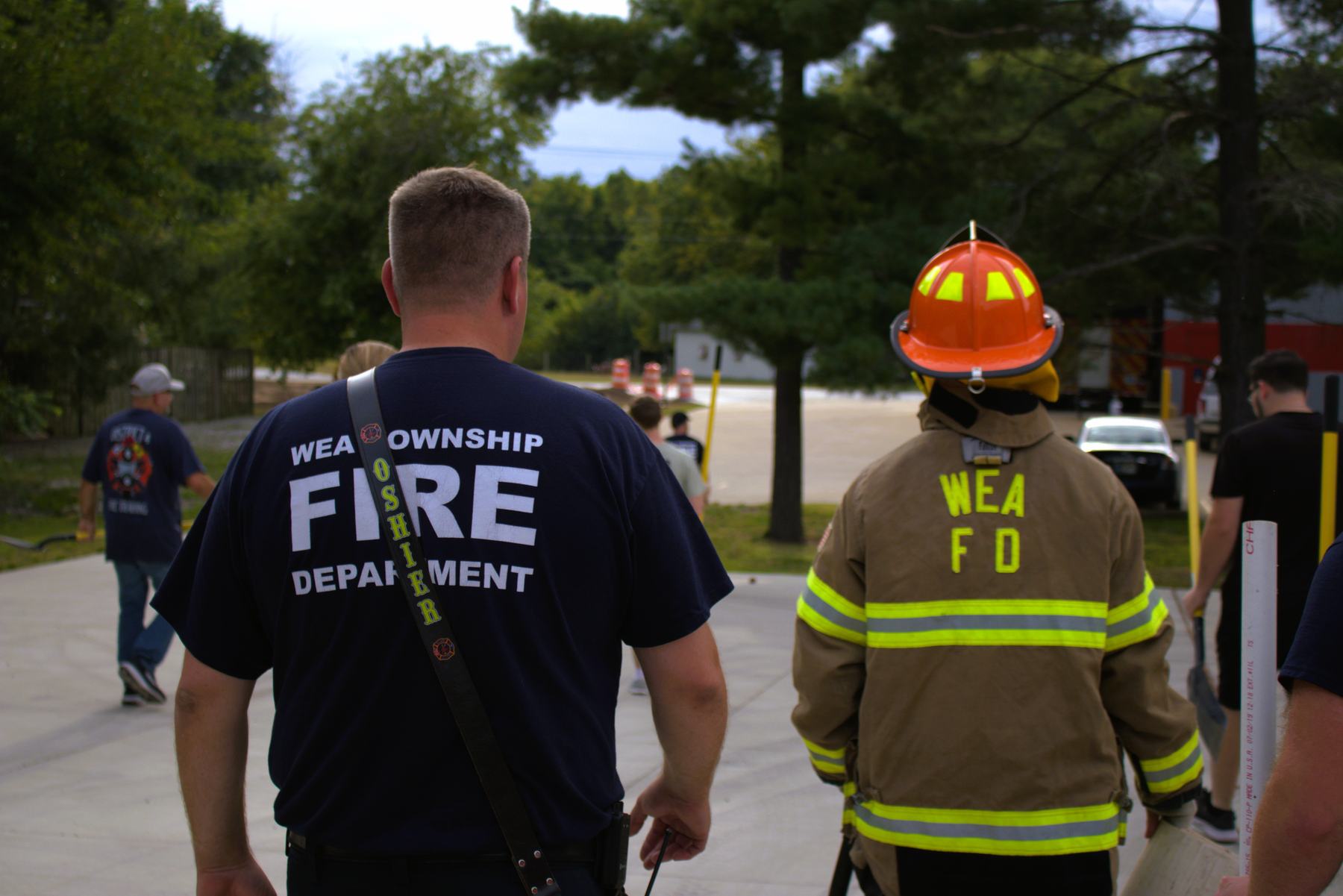 Recruits walking out to a training evolution with a firefighter