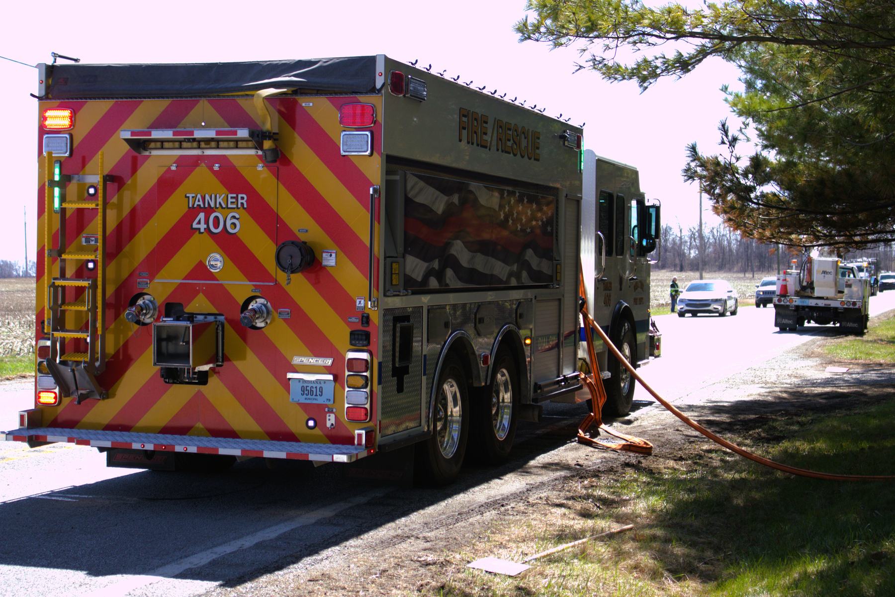 Tanker 406 parked on a rural road with supply hose