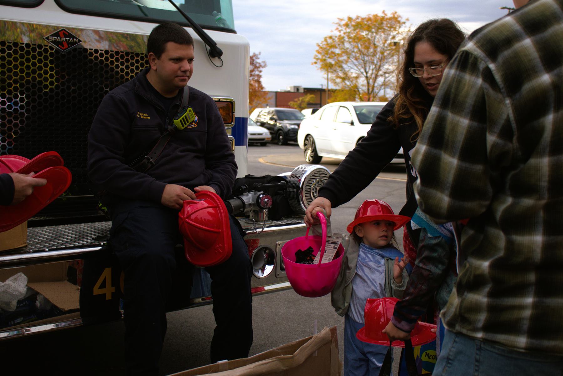 Captain greeting a child beside the engine at a community event