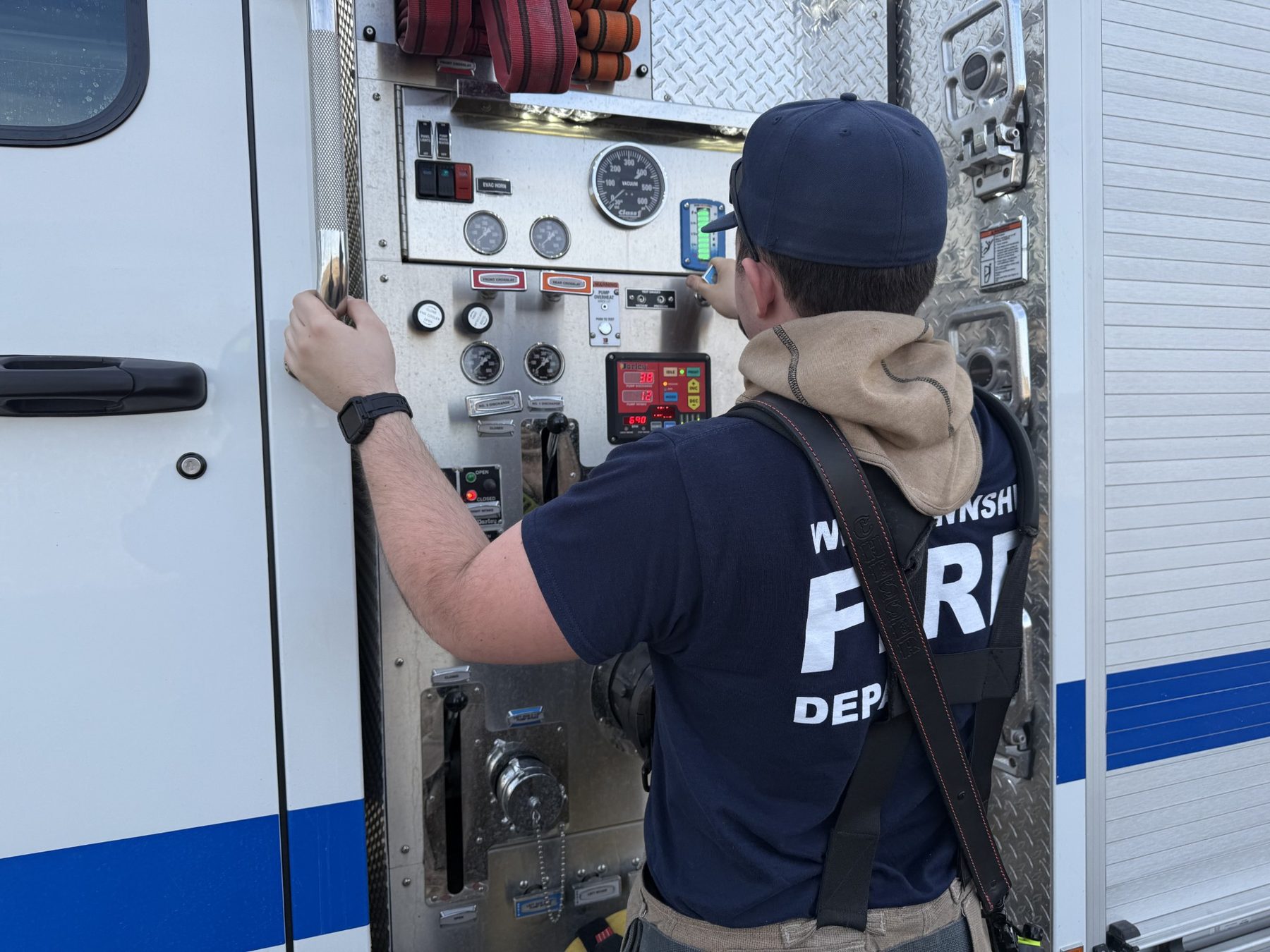 Firefighter at the pump panel of an engine